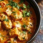 A vibrant plate of Gordon Ramsay's Creamy Tikka Masala featuring tender chicken in a rich, spiced tomato sauce garnished with fresh cilantro.